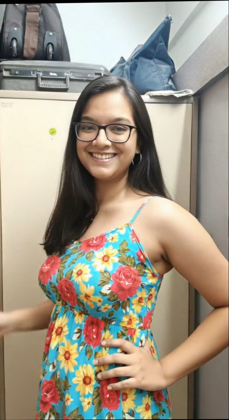 smiling Indian girl in glasses goes nude for